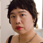 Self-portrait of Salina Kuo, Chinese-American musician. They are photographed from the shoulders up and making direct eye with the viewer.