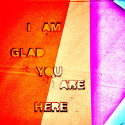 colorful geometric backlit shapes present the text "i am glad you are here" in red, dusty yellow, magenta, and cyan